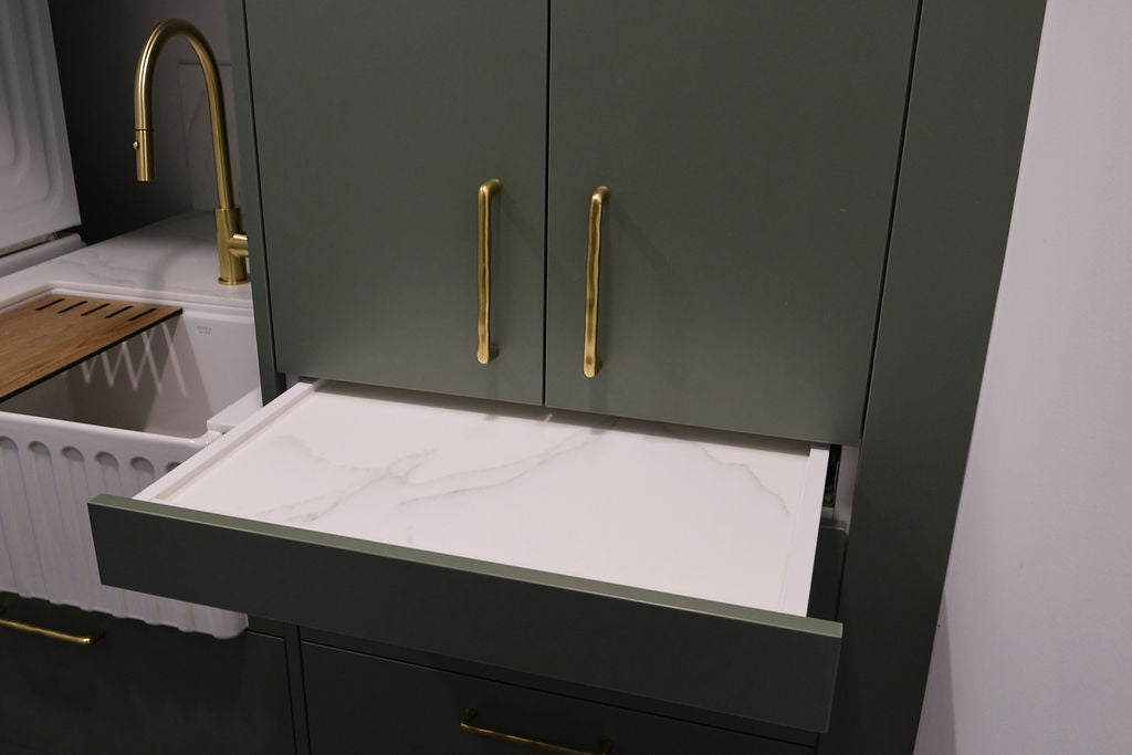 Kirsty's custom laundry with farm-style butler's sink and Staron acrylic bench to and Blum pullout locking shelf with Staron Acrylic base and some beautiful antique brass handles