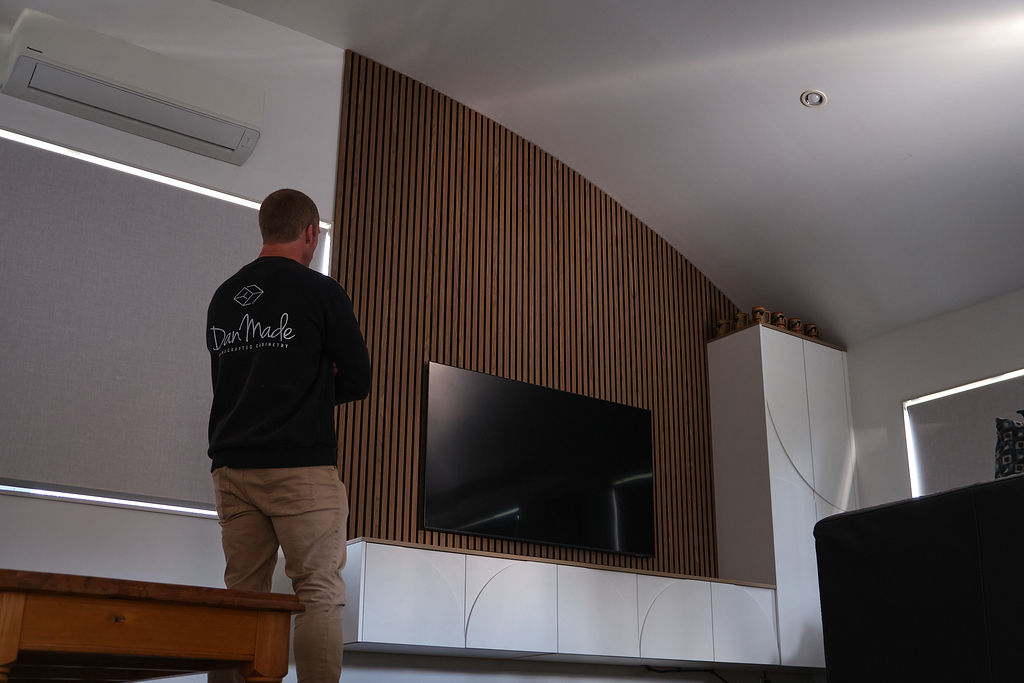 Dan from Danmade standing in front of Ilse's new custon TV unit